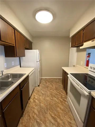 a kitchen with a sink and a refrigerator