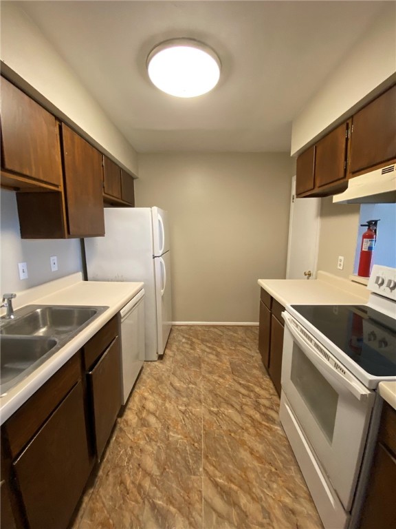 4229 Interstate Highway, Unit 3 Corpus Christi, TX 78410 - Photo 5 of 16 a kitchen with a sink stove and cabinets