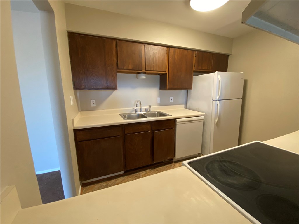 4229 Interstate Highway, Unit 3 Corpus Christi, TX 78410 - Photo 6 of 16 a kitchen with a sink and a refrigerator