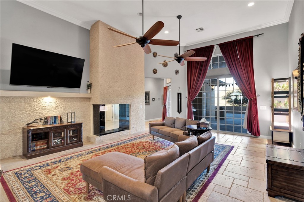 15485 Barker Road Apple Valley, CA 92307 - Photo 16 of 64 a living room with furniture a flat screen tv and a fireplace