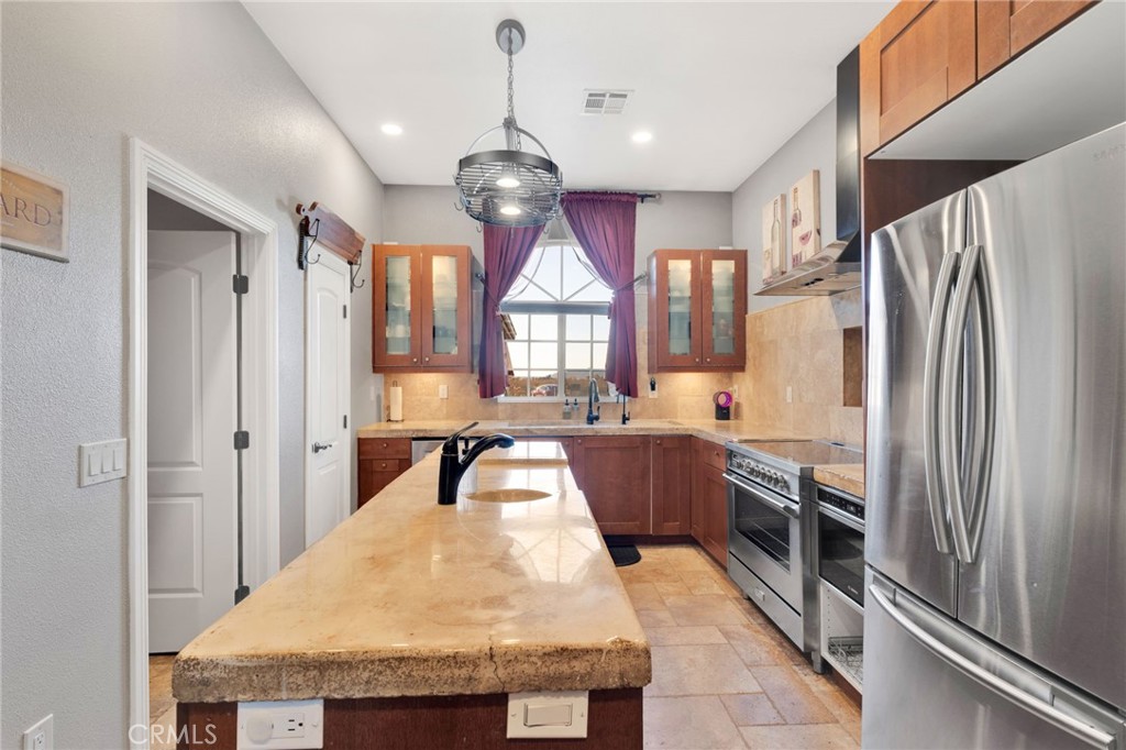 15485 Barker Road Apple Valley, CA 92307 - Photo 22 of 64 a kitchen with stainless steel appliances granite countertop a refrigerator a sink dishwasher a stove and a refrigerator