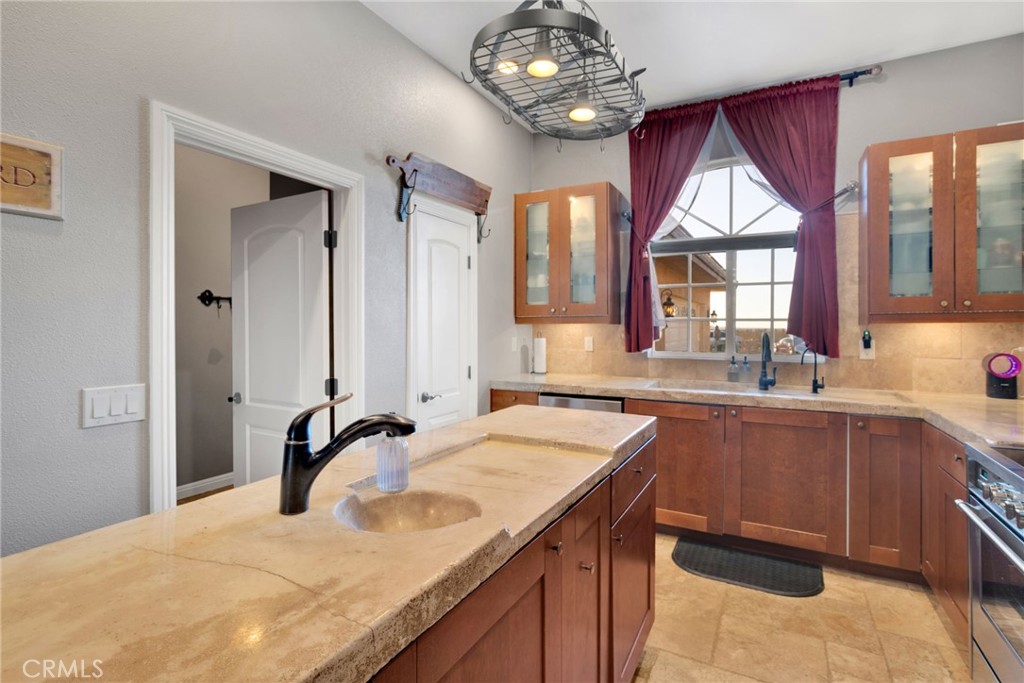 15485 Barker Road Apple Valley, CA 92307 - Photo 23 of 64 a spacious bathroom with a granite countertop sink a large mirror and a bathtub