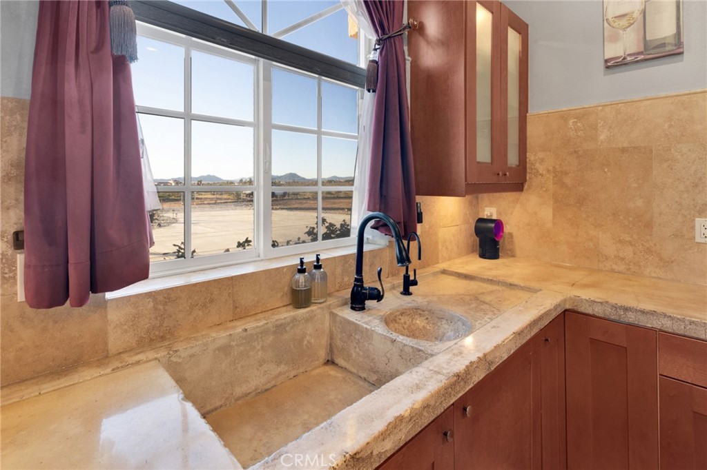 15485 Barker Road Apple Valley, CA 92307 - Photo 25 of 64 a kitchen with a sink and a large window