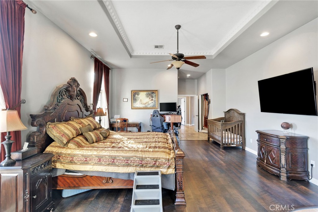 15485 Barker Road Apple Valley, CA 92307 - Photo 29 of 64 a bedroom with a bed and a flat screen tv