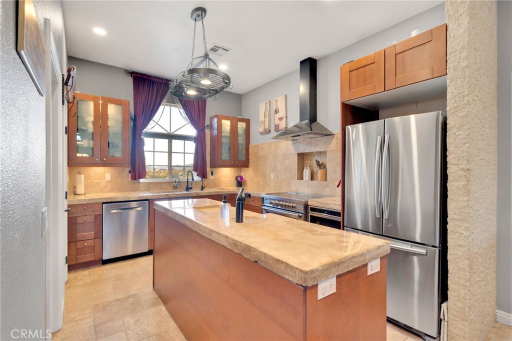 15485 Barker Road Apple Valley, CA 92307 - Photo 3 of 64 a kitchen with stainless steel appliances granite countertop a refrigerator a sink dishwasher a oven with white cabinets and wooden floor