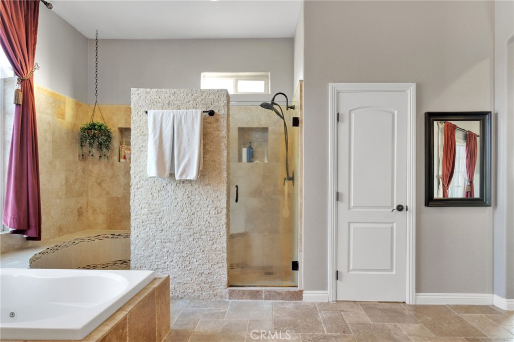 15485 Barker Road Apple Valley, CA 92307 - Photo 31 of 64 a bathroom with a granite countertop tub sink shower and mirror