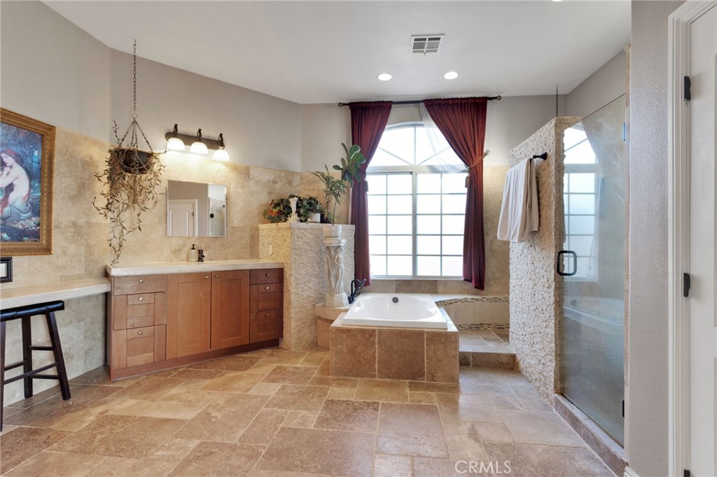 15485 Barker Road Apple Valley, CA 92307 - Photo 34 of 64 a large bathroom with a tub sink and mirror