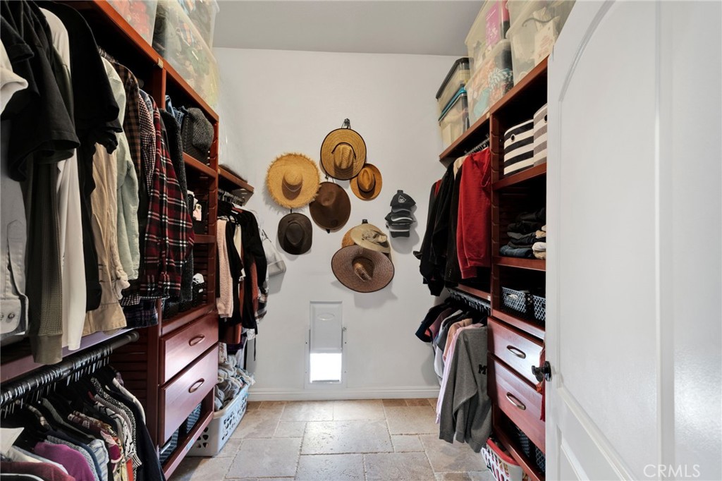 15485 Barker Road Apple Valley, CA 92307 - Photo 35 of 64 a view of walk in closet with clothes and shoes