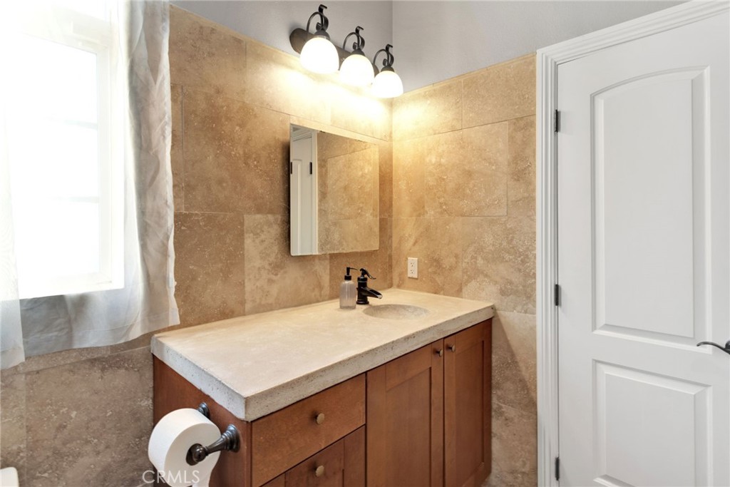 15485 Barker Road Apple Valley, CA 92307 - Photo 39 of 64 a bathroom with a sink vanity and a mirror