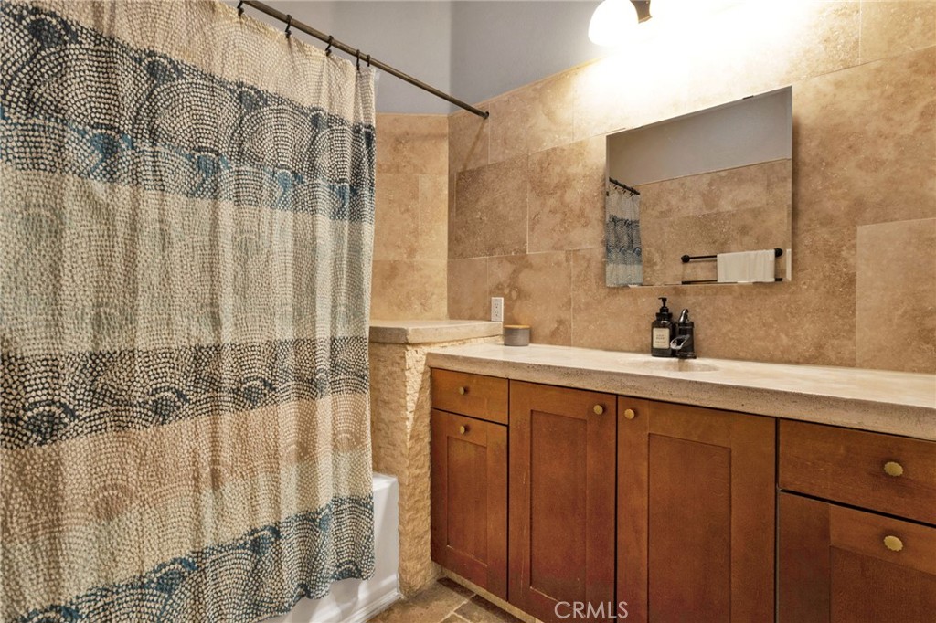 15485 Barker Road Apple Valley, CA 92307 - Photo 46 of 64 a bathroom with a double vanity sink and a mirror