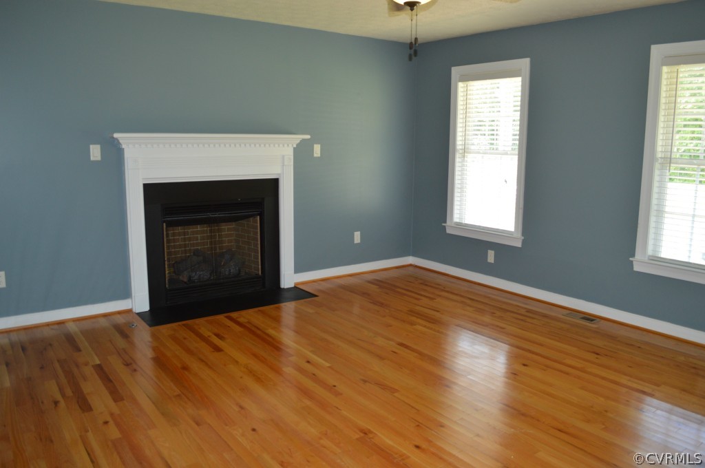 10755 Baltimore Road Ford, VA 23850 - Photo 7 of 23 a view of empty room with wooden floor and fireplace