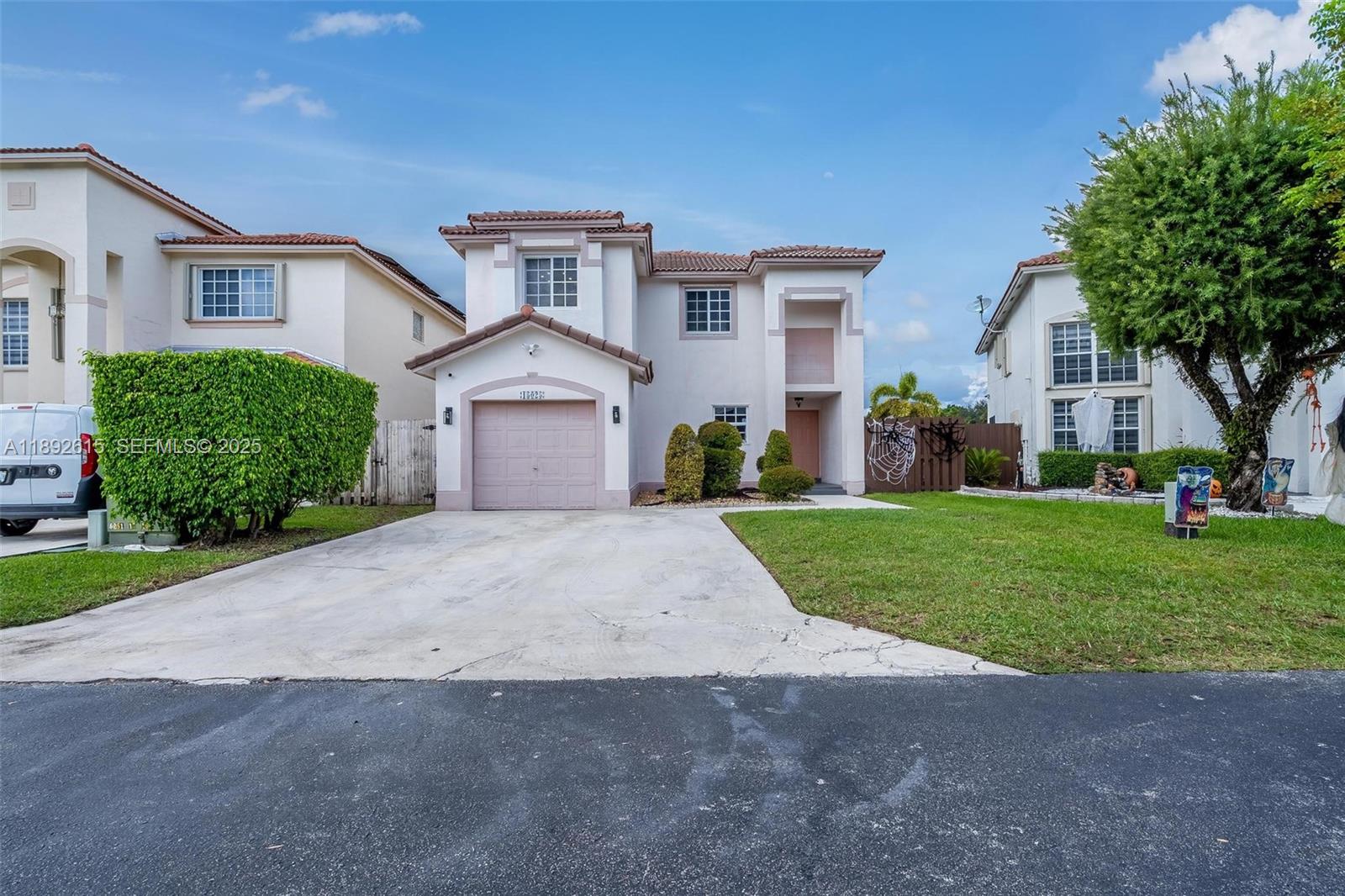 a front view of a house with a yard and garage