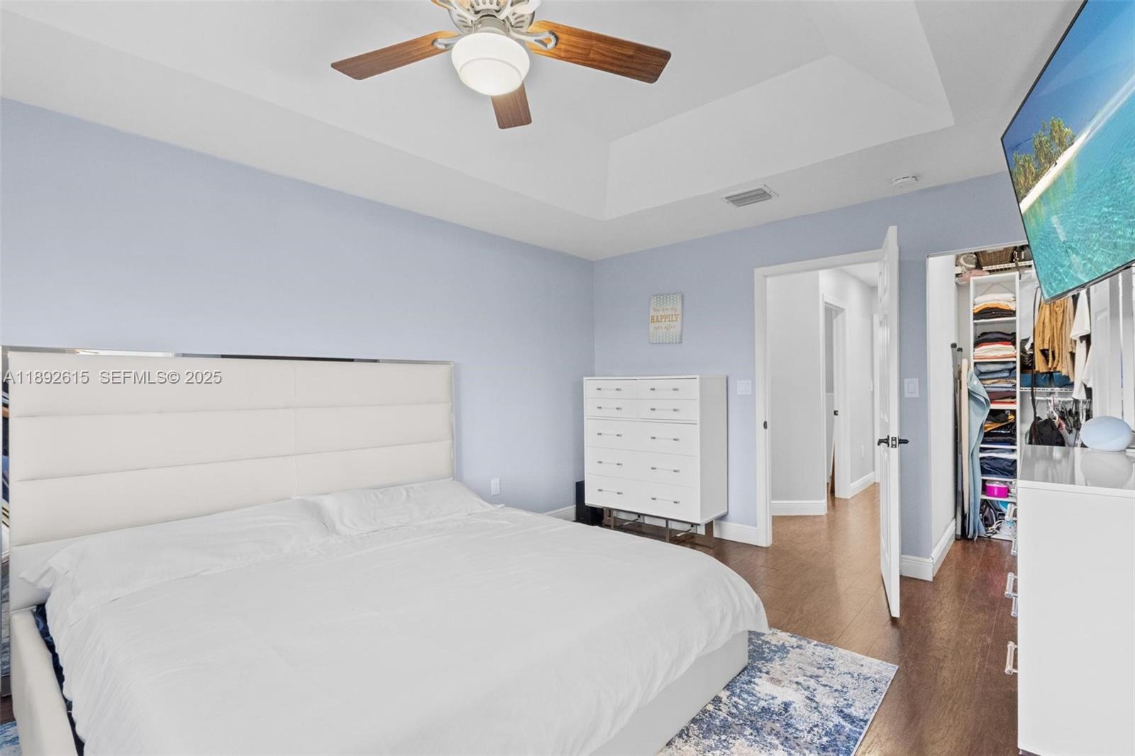 15025 Southwest 141st Terrace Miami, FL 33196 - Photo 13 of 34 a bedroom with a bed and a chandelier