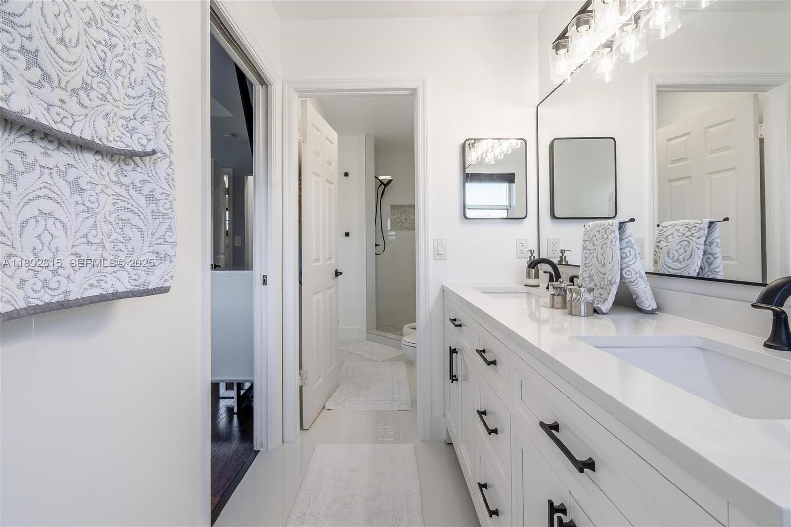 15025 Southwest 141st Terrace Miami, FL 33196 - Photo 15 of 34 a spacious bathroom with a double vanity sink mirror and double