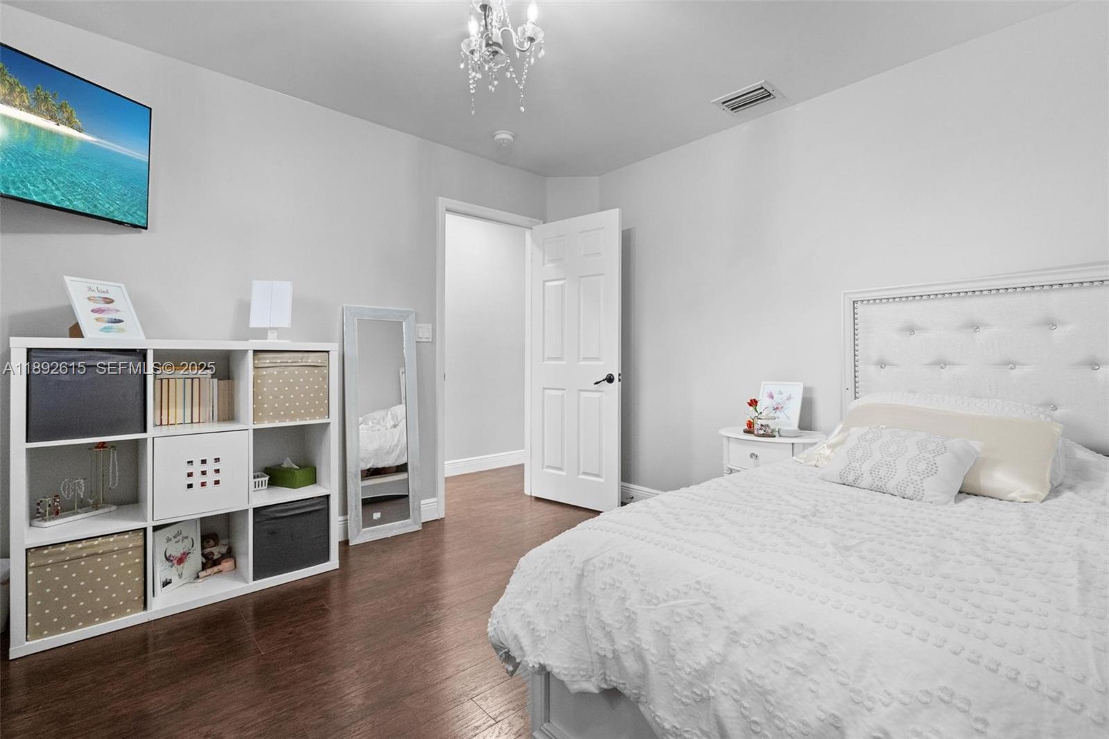 15025 Southwest 141st Terrace Miami, FL 33196 - Photo 19 of 34 a bedroom with a bed and a flat screen tv