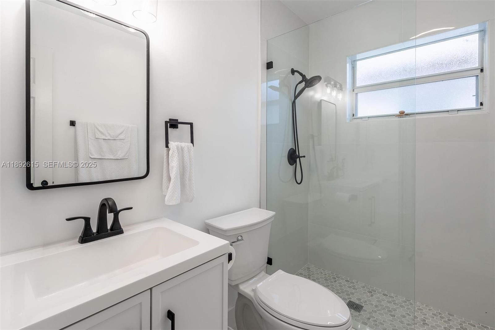15025 Southwest 141st Terrace Miami, FL 33196 - Photo 21 of 34 a bathroom with a sink toilet and shower