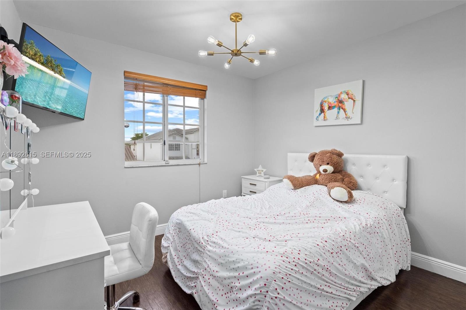 15025 Southwest 141st Terrace Miami, FL 33196 - Photo 22 of 34 a bedroom with a bed and a table