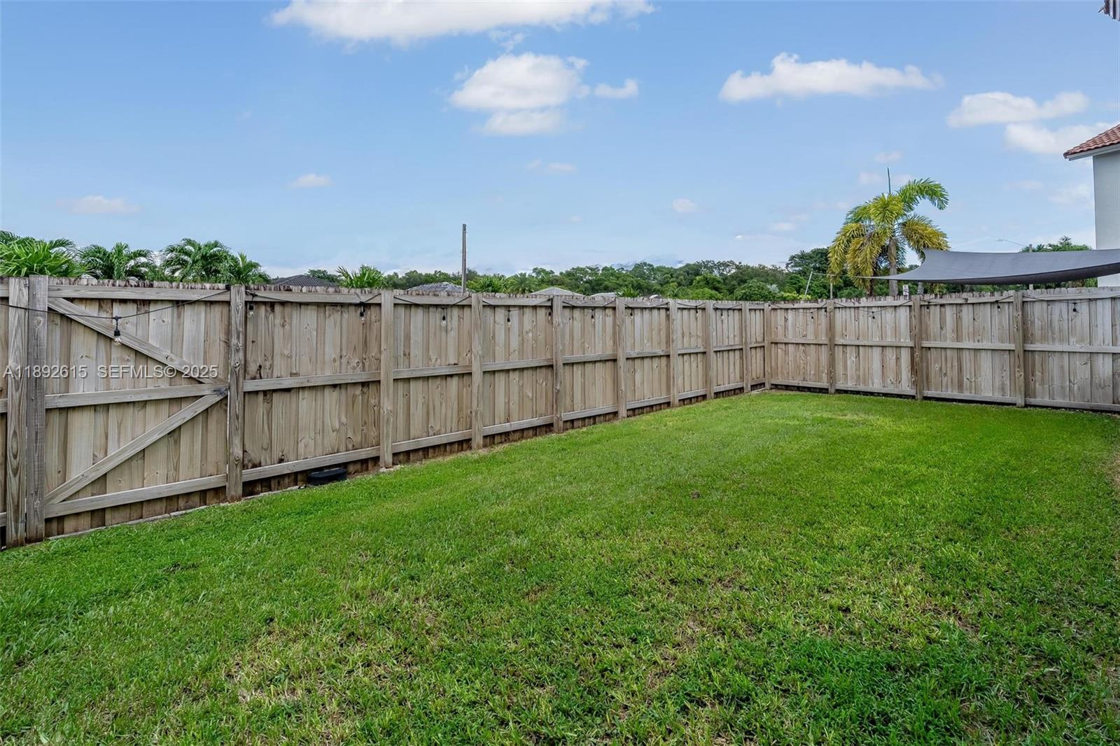15025 Southwest 141st Terrace Miami, FL 33196 - Photo 28 of 34 a view of a backyard with a fence and plants