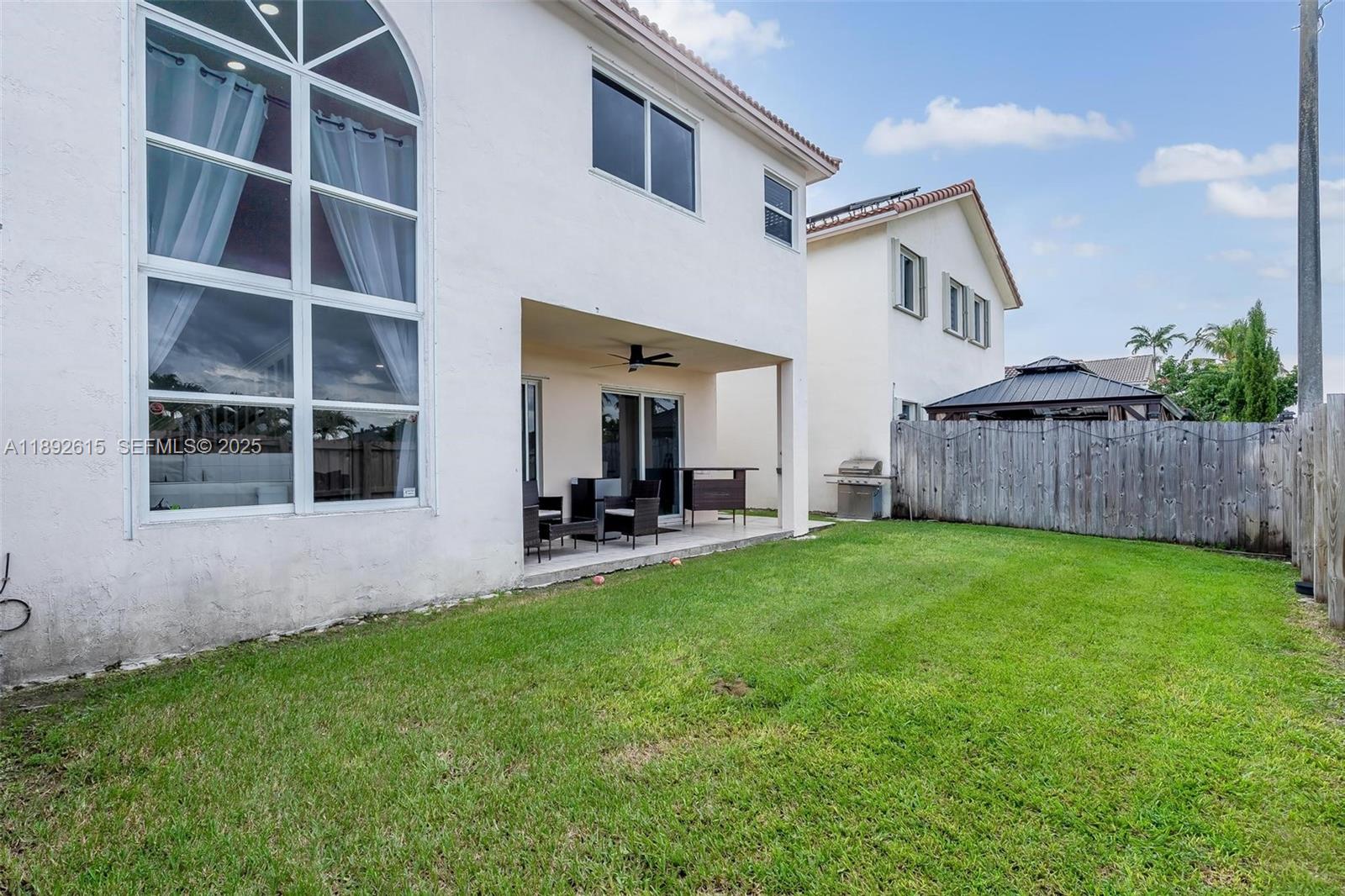 15025 Southwest 141st Terrace Miami, FL 33196 - Photo 29 of 34 a view of a house with backyard and porch