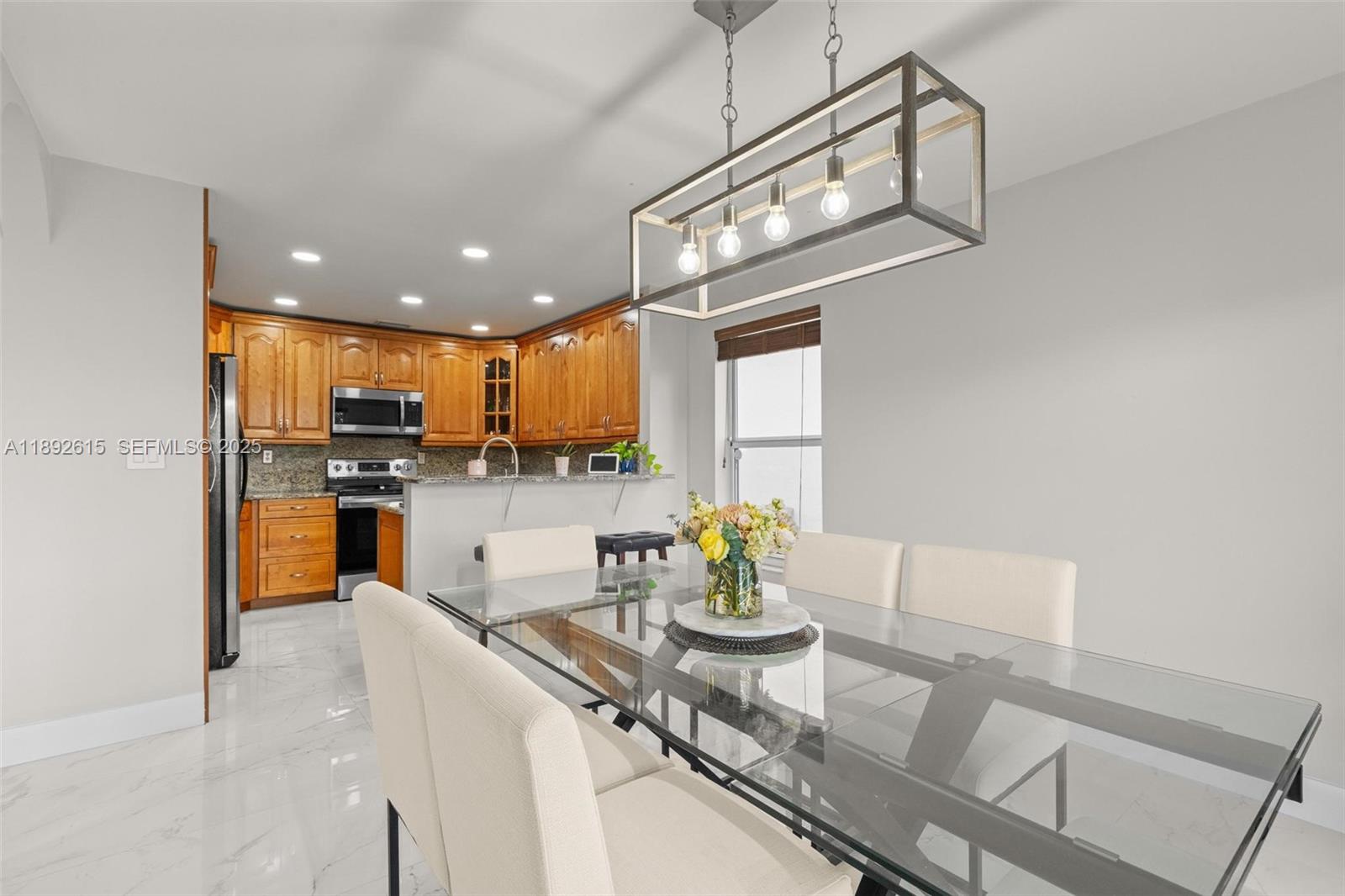 15025 Southwest 141st Terrace Miami, FL 33196 - Photo 3 of 34 a kitchen with stainless steel appliances granite countertop a sink and cabinets