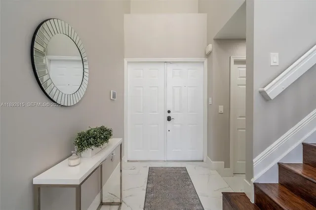 a view of an entryway with wooden floor and mirror