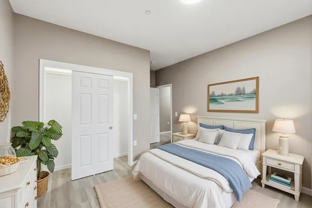 a bedroom with a bed and a potted plant