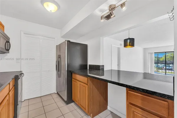 a view of a refrigerator a sink and dishwasher in a kitchen