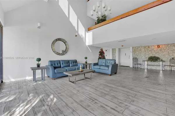 a living room with furniture and a chandelier