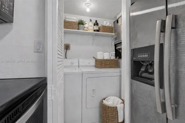 a kitchen with stainless steel appliances granite countertop a refrigerator and a stove