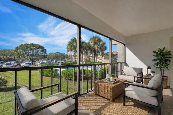 a balcony with furniture and a potted plant