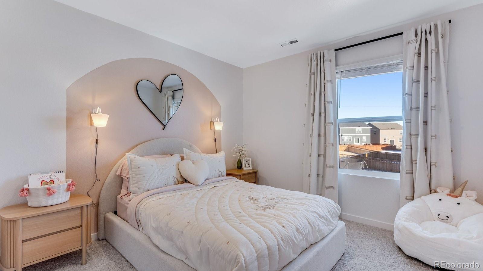 799 Ayrshire Road Johnstown, CO 80534 - Photo 23 of 36 a bedroom with a bed and a chandelier