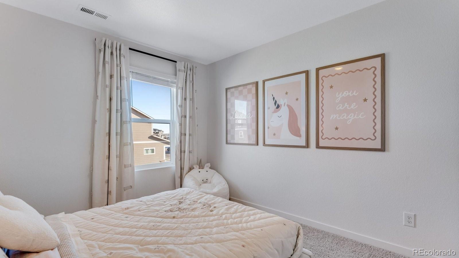 799 Ayrshire Road Johnstown, CO 80534 - Photo 24 of 36 a bedroom with a bed and a window