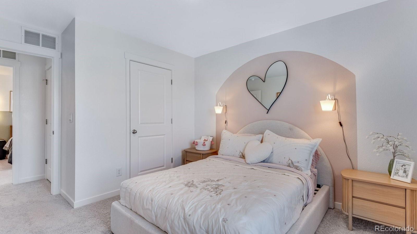 799 Ayrshire Road Johnstown, CO 80534 - Photo 25 of 36 a bedroom with a bed and a chandelier