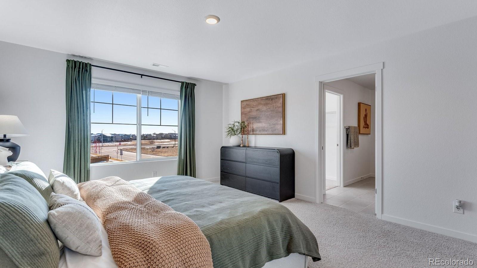 799 Ayrshire Road Johnstown, CO 80534 - Photo 30 of 36 a bedroom with a bed and a large window