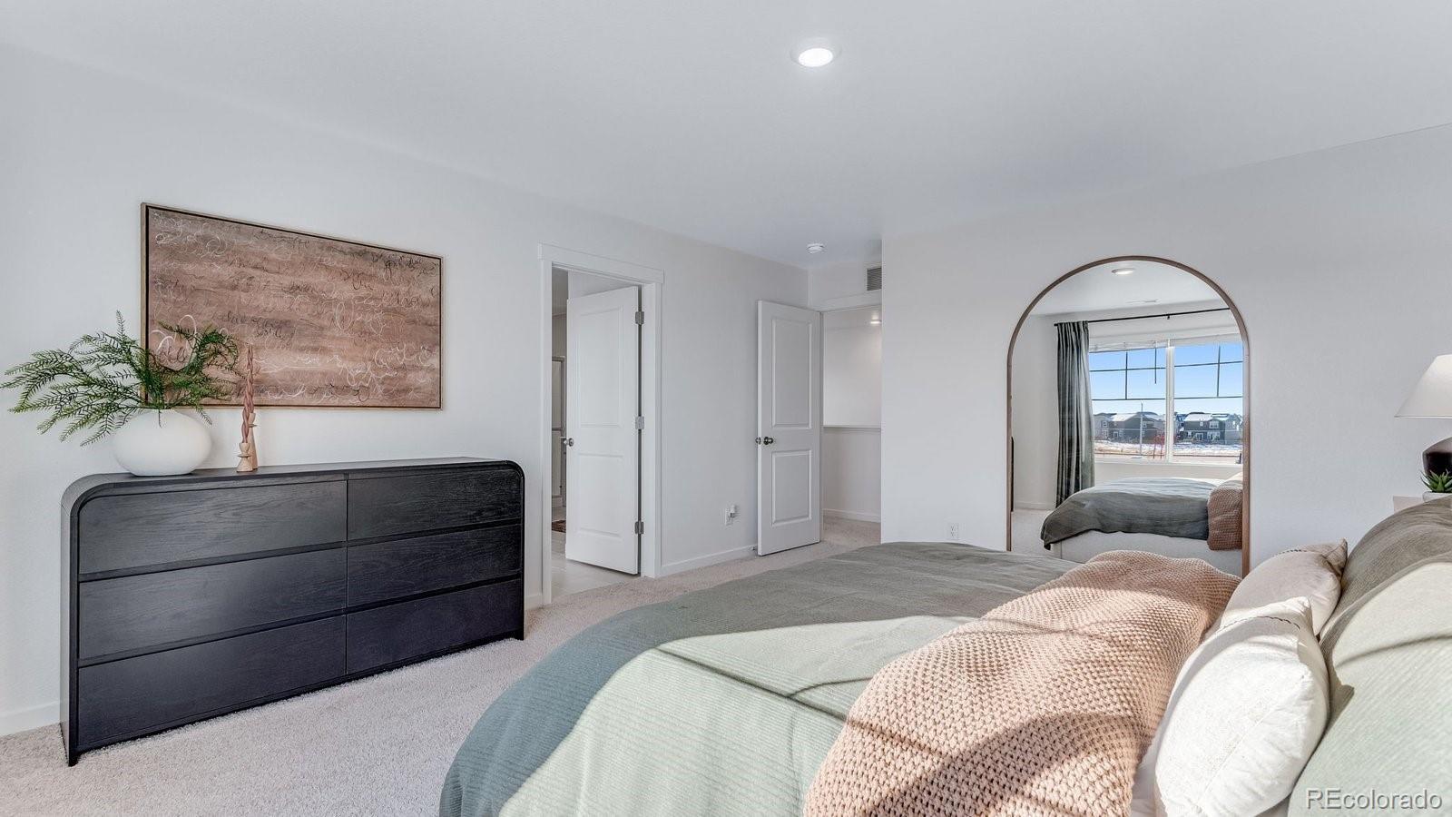 799 Ayrshire Road Johnstown, CO 80534 - Photo 31 of 36 a bedroom with a bed and a potted plant