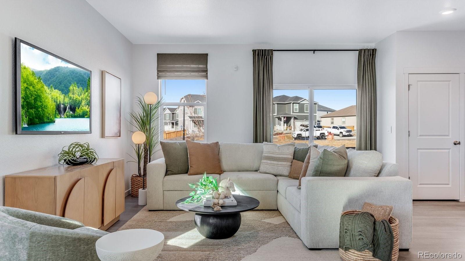 799 Ayrshire Road Johnstown, CO 80534 - Photo 7 of 36 a living room with furniture and a large window