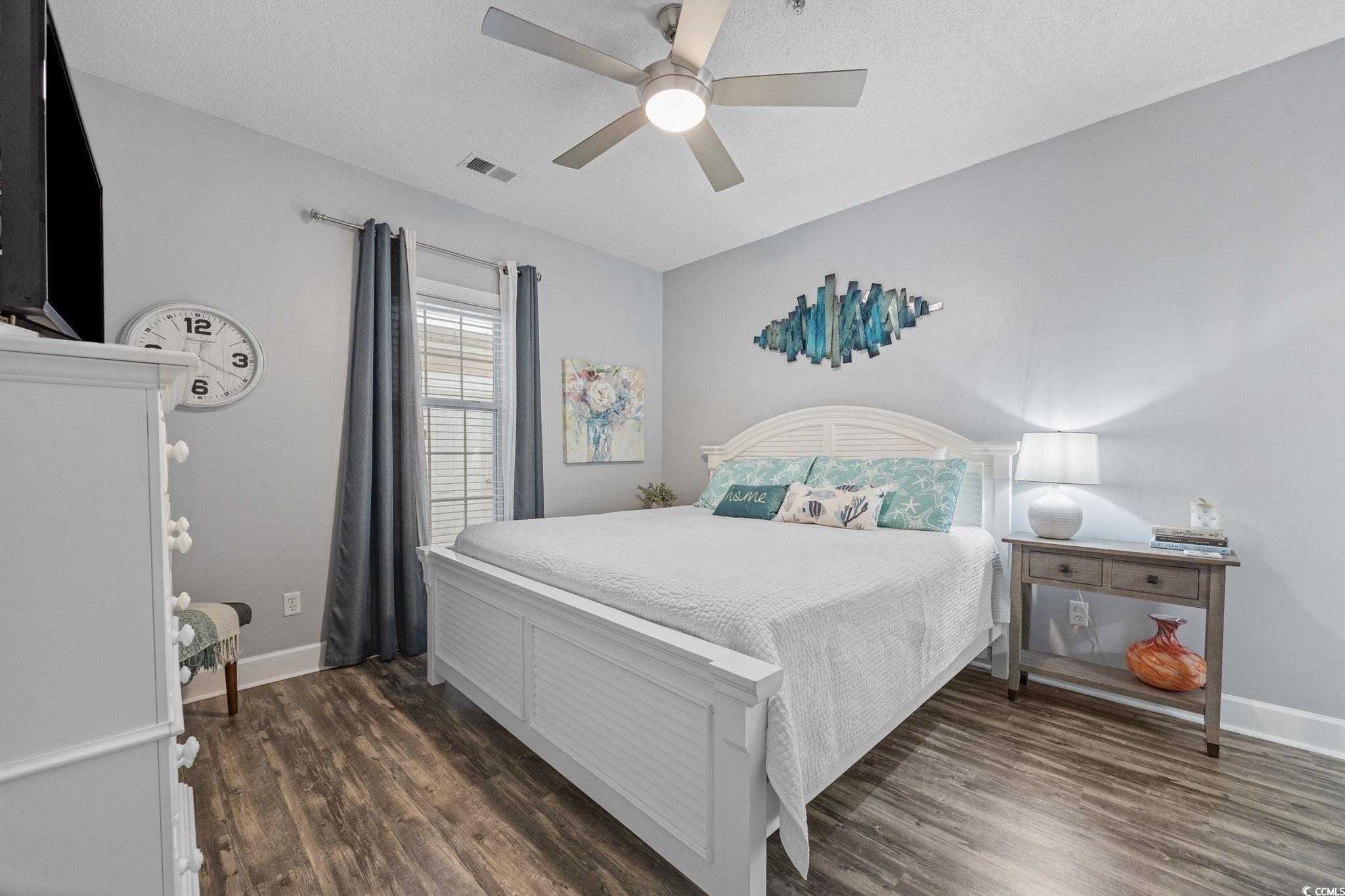 4846 Carnation Circle, Unit 103 Myrtle Beach, SC 29577 - Photo 14 of 31 Bedroom featuring dark wood finished floors and ceiling fan
