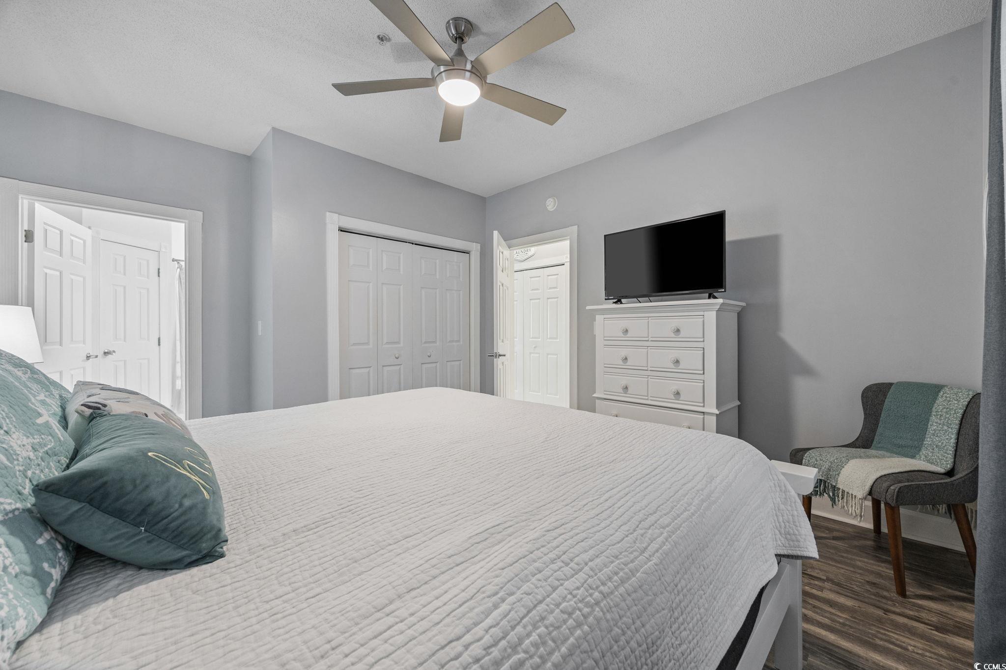 4846 Carnation Circle, Unit 103 Myrtle Beach, SC 29577 - Photo 15 of 31 Bedroom with a closet, dark wood-style floors, and ceiling fan