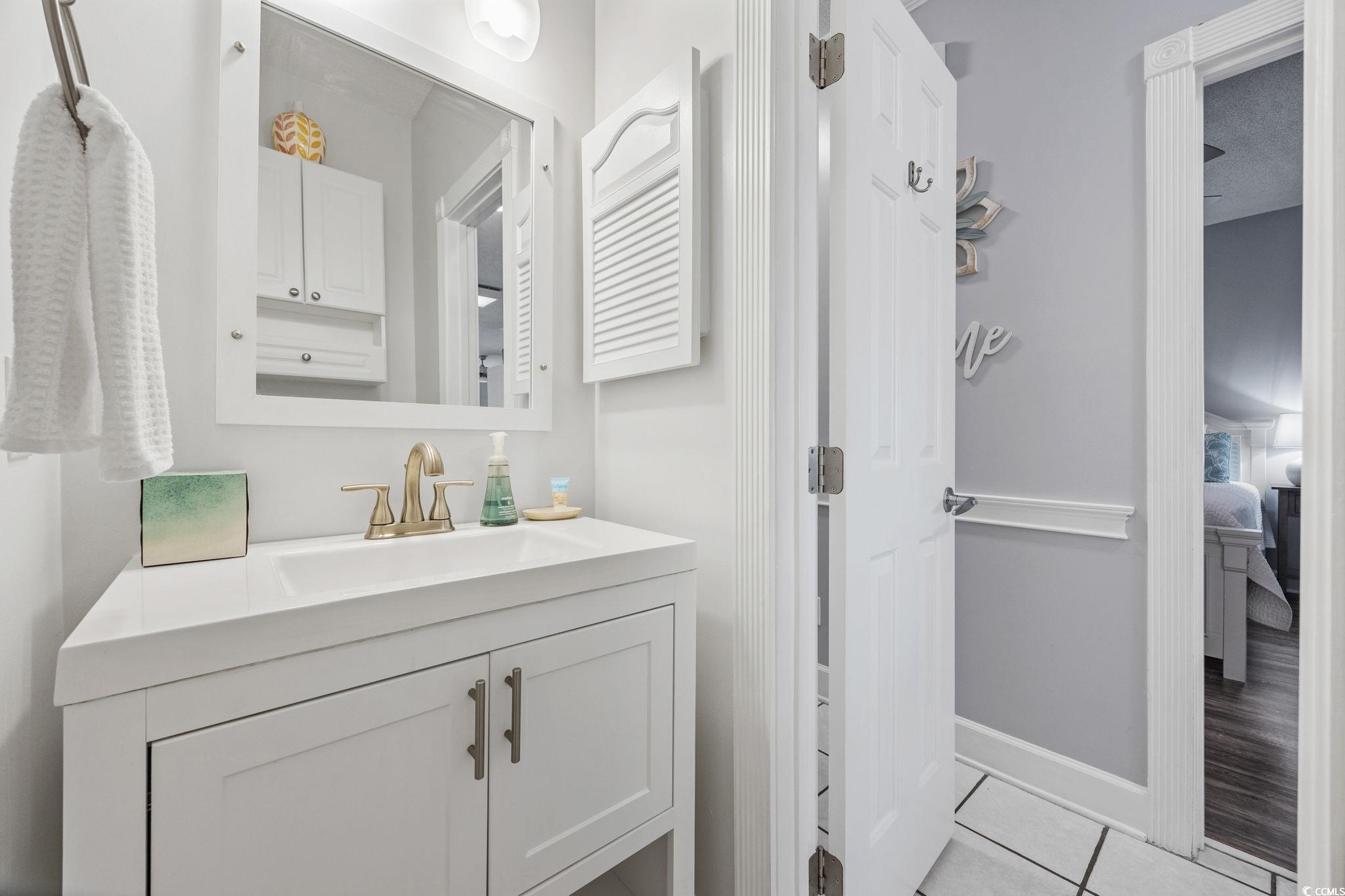 4846 Carnation Circle, Unit 103 Myrtle Beach, SC 29577 - Photo 17 of 31 Bathroom with vanity, tile patterned flooring, and ensuite bath
