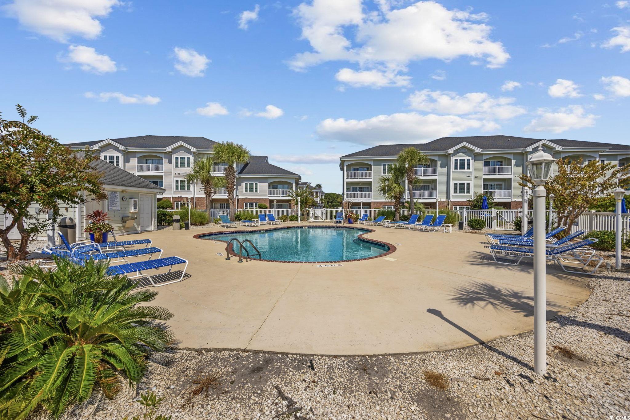4846 Carnation Circle, Unit 103 Myrtle Beach, SC 29577 - Photo 20 of 31 Community pool with a residential view and a patio area