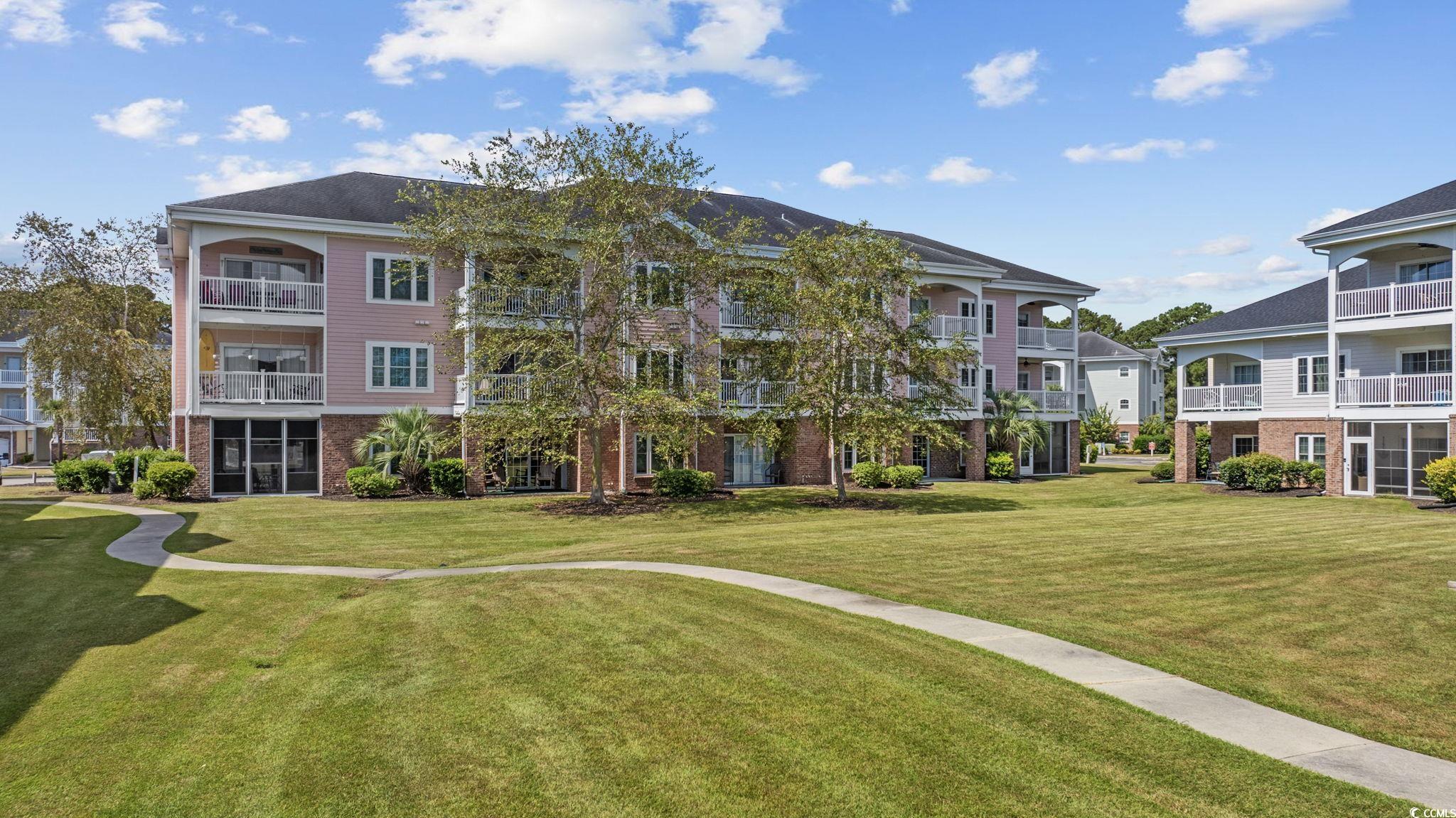 4846 Carnation Circle, Unit 103 Myrtle Beach, SC 29577 - Photo 25 of 31 View of community with a yard and a balcony