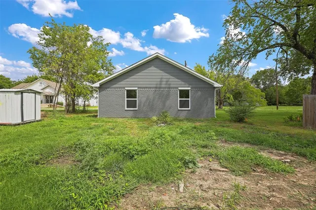 a view of a house with yard and a garden