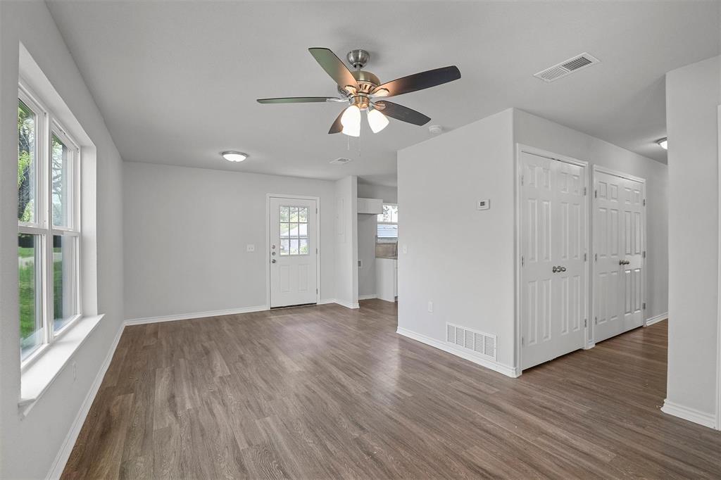 317 Jones Street Bonham, TX 75418 - Photo 5 of 15 Unfurnished living room with wood finished floors and ceiling fan