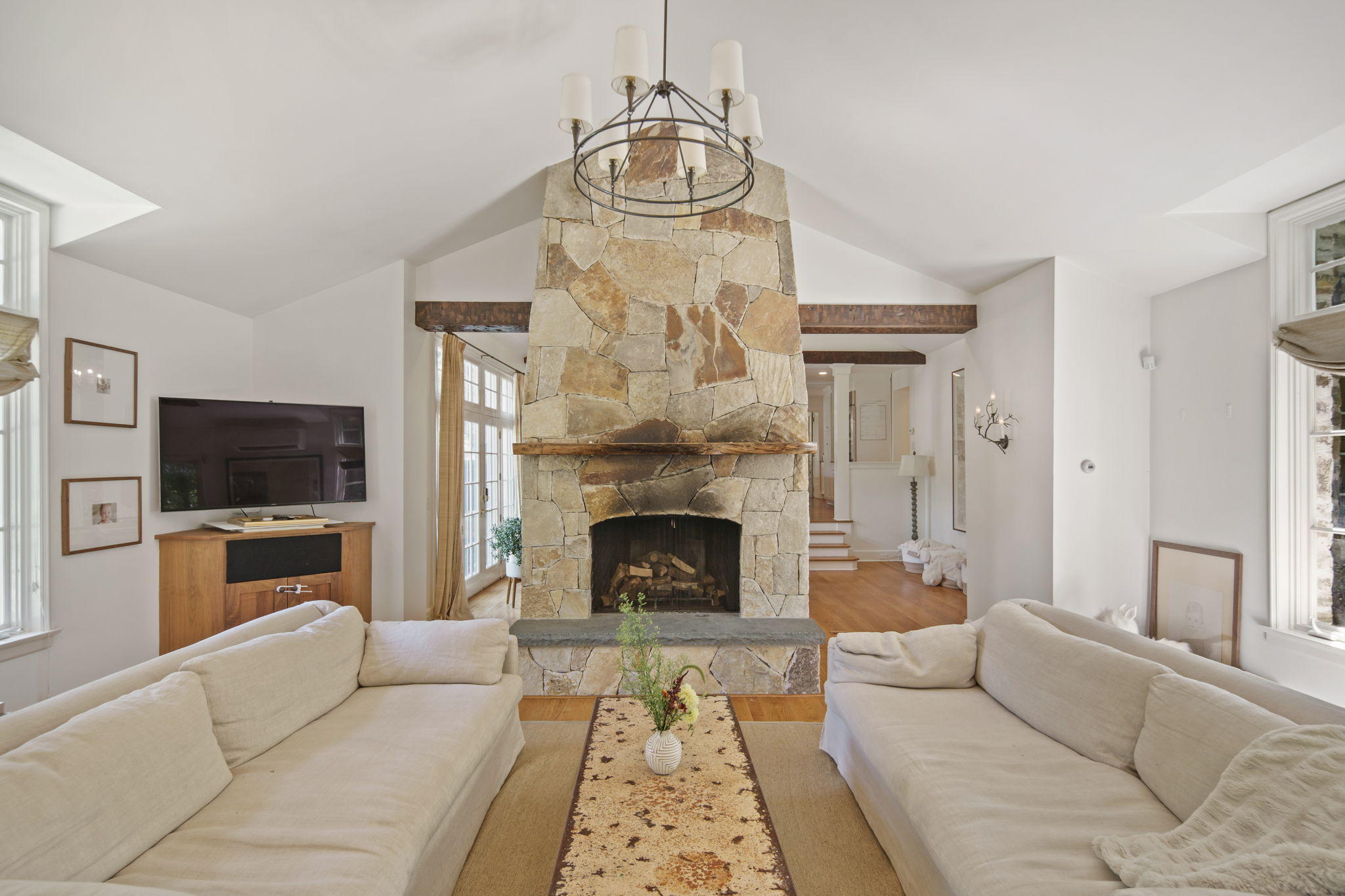 231 Cannon Road Wilton, CT 06897 - Photo 13 of 48 a living room with furniture a flat screen tv and a fireplace