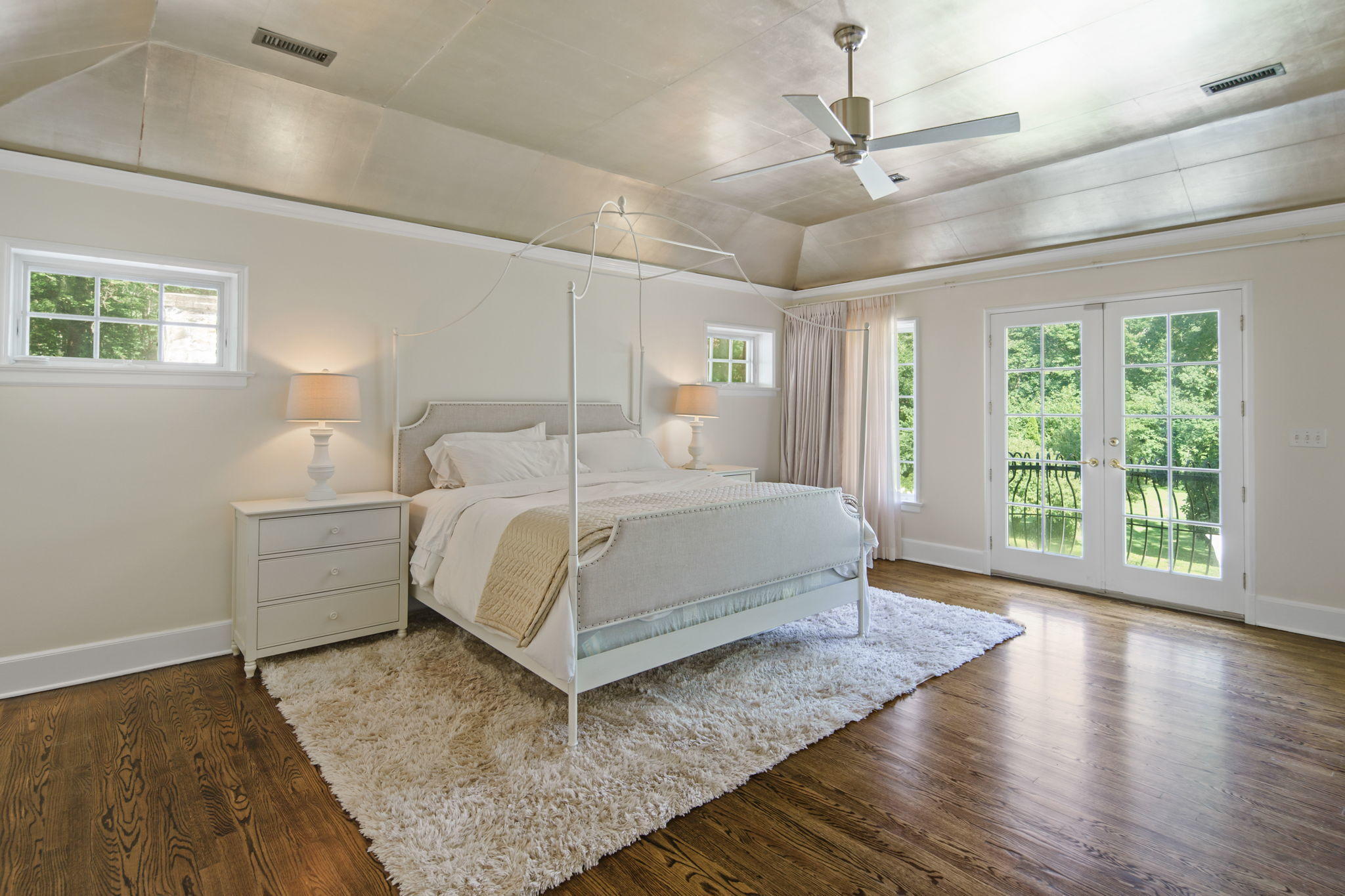 231 Cannon Road Wilton, CT 06897 - Photo 19 of 48 a bedroom with a large bed chandelier and a window