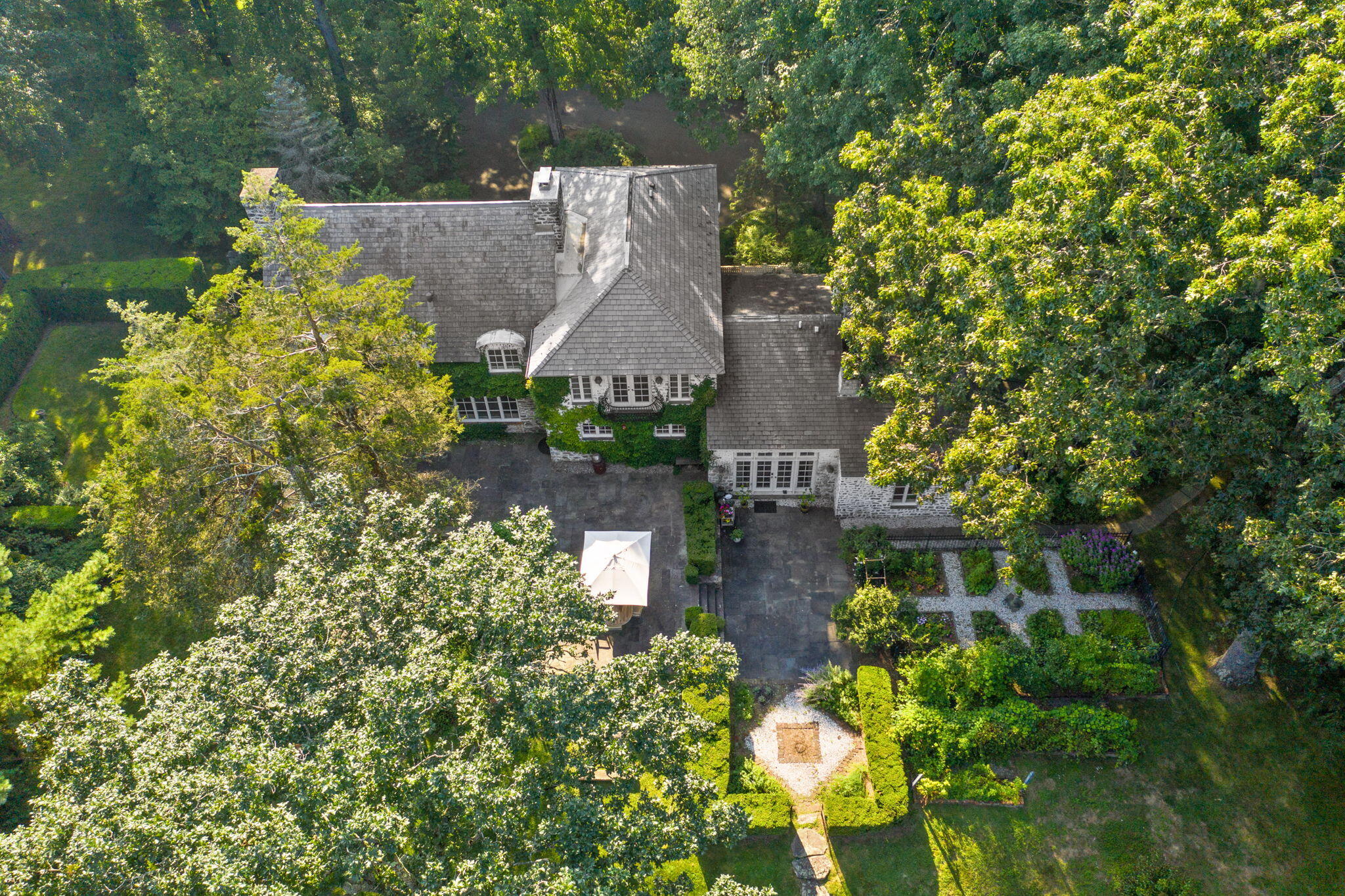 231 Cannon Road Wilton, CT 06897 - Photo 46 of 48 an aerial view of a house with a yard and garden