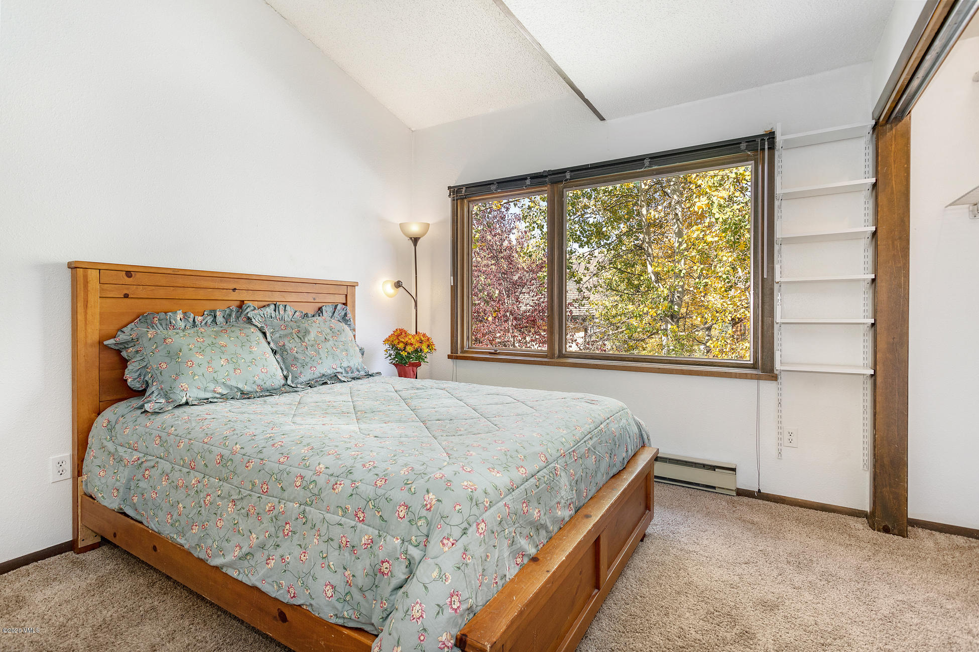 225 Gopher Road, Unit H54 Avon, CO 81620 - Photo 11 of 33 a bed sitting in a bedroom next to a window