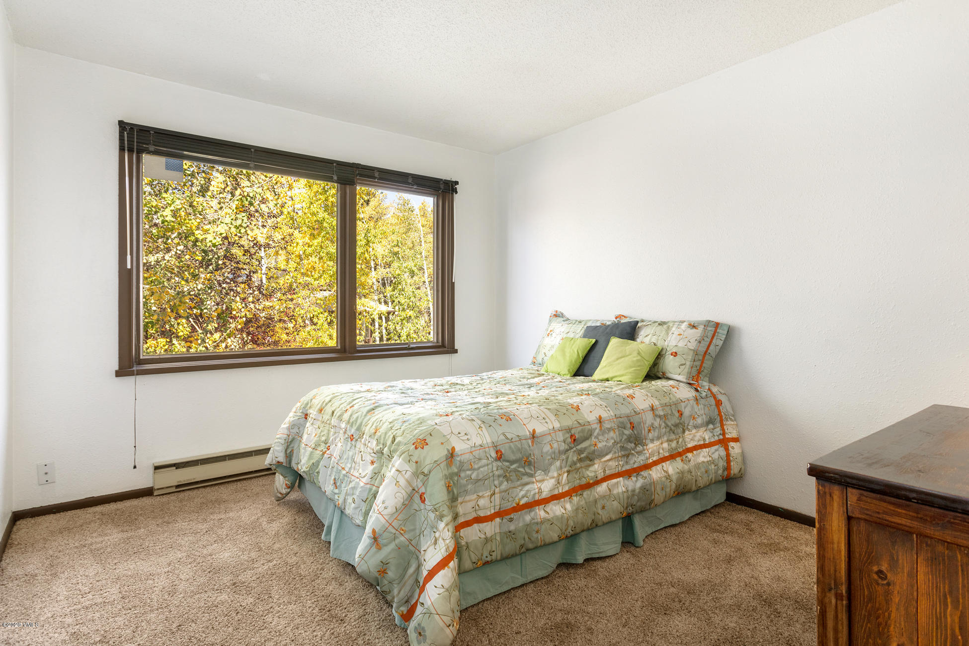 225 Gopher Road, Unit H54 Avon, CO 81620 - Photo 13 of 33 a bed sitting in a bedroom next to a window