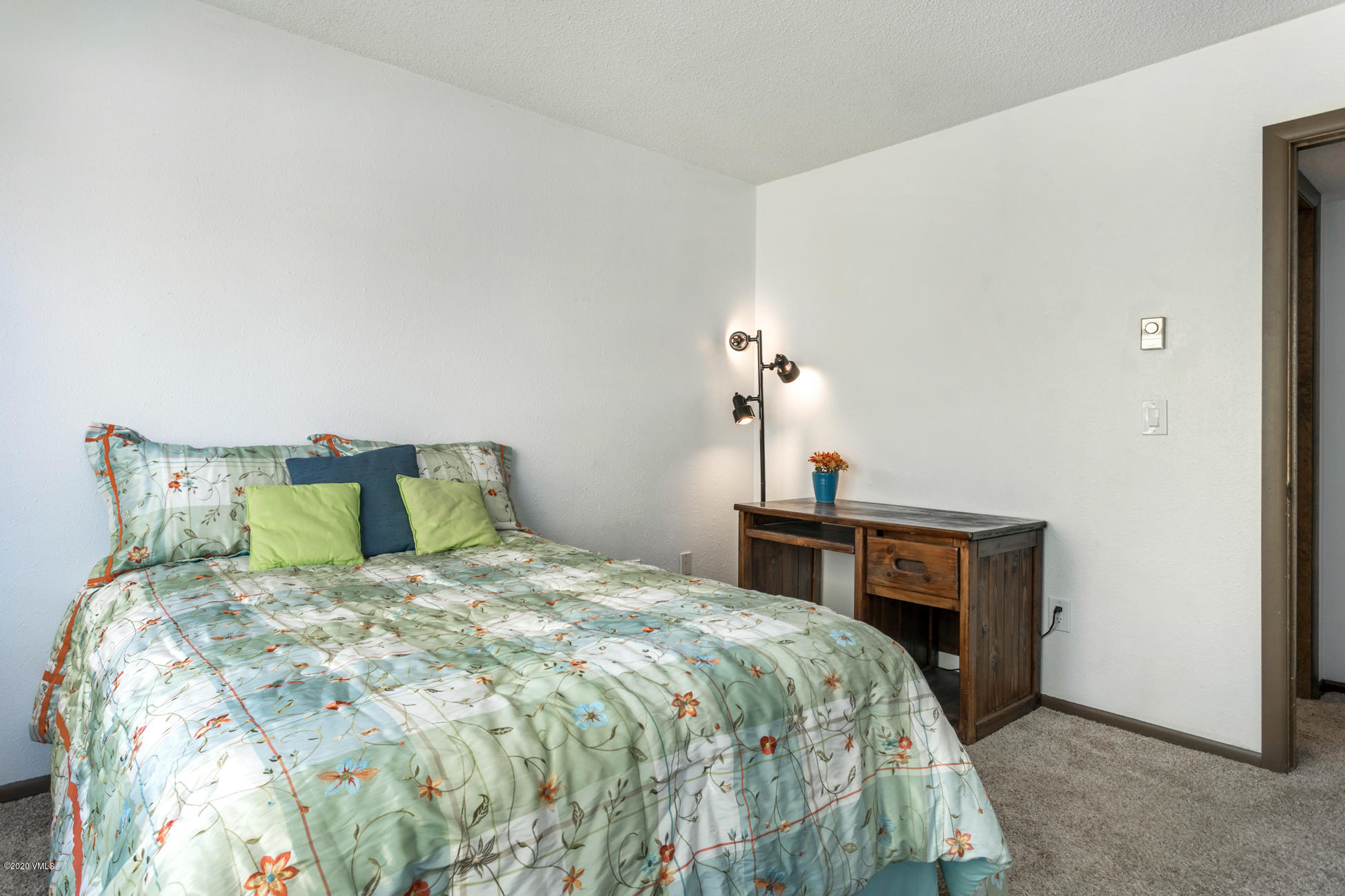 225 Gopher Road, Unit H54 Avon, CO 81620 - Photo 14 of 33 a bedroom with a bed and a table