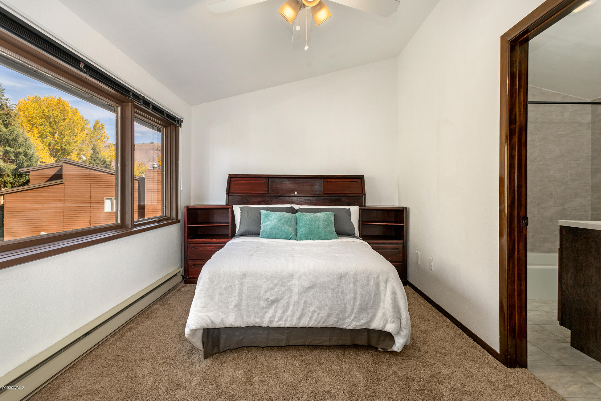 225 Gopher Road, Unit H54 Avon, CO 81620 - Photo 19 of 33 a bedroom with a bed lamp and window